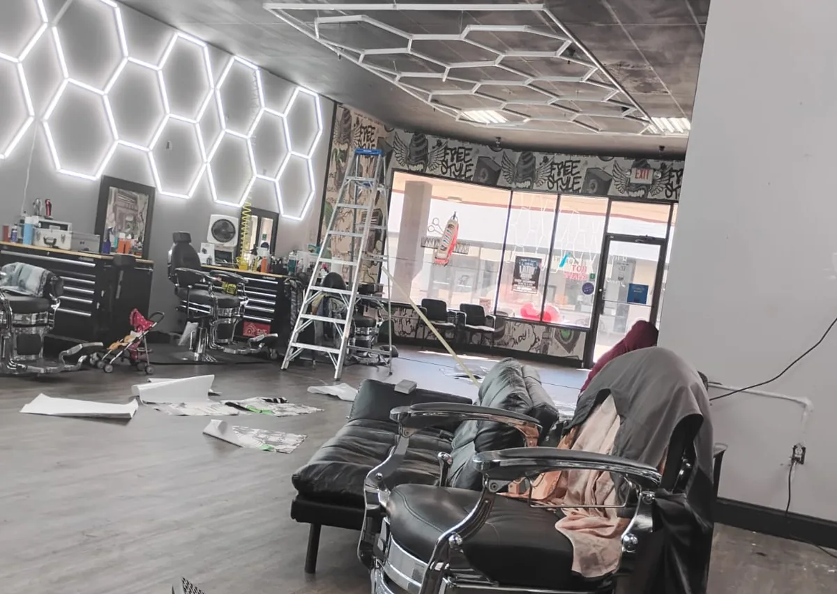 Barbershop build-out with hexagon LED ceiling lighting and new floor